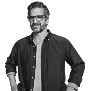 Individual in a sweater with hand on chin.