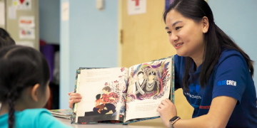 Image of Jeannie Cai, corporate compliance analyst, reading a book to daycare children with her quote about the many ways to serve the community through Blue Cross Image of Jeannie Cai, corporate compliance analyst, reading a book to daycare children with her quote about the many ways to serve the community through Blue Cross