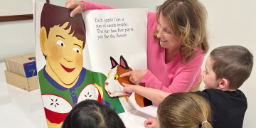 Photo of nonprofit leader Karen Smizer of South Shore Stars reading to children with quote about feeling grateful to Blue Cross for donated tables and chairs Photo of nonprofit leader Karen Smizer of South Shore Stars reading to children with quote about feeling grateful to Blue Cross for donated tables and chairs