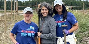 Liz Wiley, Marion Institute exec. director, stands in farmland with two Blue Cross volunteers with a quote on the value of connecting with fellow nonprofit leaders Liz Wiley, Marion Institute exec. director, stands in farmland with two Blue Cross volunteers with a quote on the value of connecting with fellow nonprofit leaders